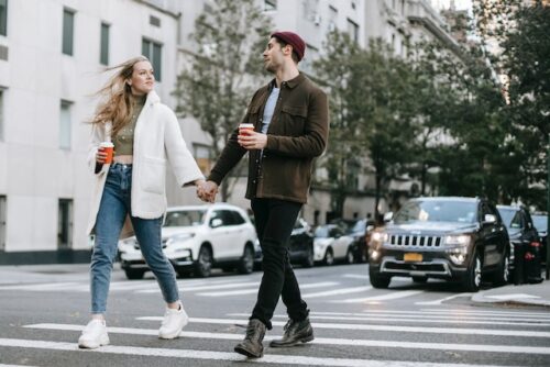two people crossing street