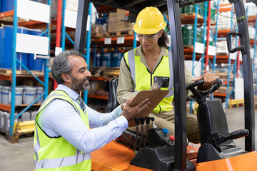 two workers on machine in workplace